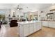 Bright kitchen features a large island, tile flooring, and seamless transition into an adjacent living room with a fireplace at 4401 E Barwick Dr, Cave Creek, AZ 85331
