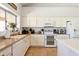 Spacious kitchen with white appliances and cabinets offers a functional layout and ample counter space for culinary activities at 4401 E Barwick Dr, Cave Creek, AZ 85331