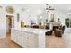 Open kitchen design highlights a seamless flow into a living room, featuring an expansive island and comfortable living space at 4401 E Barwick Dr, Cave Creek, AZ 85331