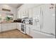 Well-lit kitchen features white cabinets, a complete range of appliances, and neutral countertops for a clean and classic look at 4401 E Barwick Dr, Cave Creek, AZ 85331