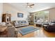 Comfortable living room with vaulted ceilings, hardwood floors, and a large window with shutters at 4401 E Barwick Dr, Cave Creek, AZ 85331