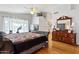 Bright main bedroom with wood flooring, a ceiling fan, and natural light at 4401 E Barwick Dr, Cave Creek, AZ 85331