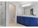 Bathroom showcasing a dual sink vanity with blue cabinets, offering both style and functionality at 4554 E Coyote Wash Dr, Cave Creek, AZ 85331