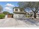 A beautiful two-story home with an attached garage and spacious driveway, set against a backdrop of lush greenery at 4554 E Coyote Wash Dr, Cave Creek, AZ 85331