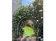 Charming garden archway covered in white flowers leads to a serene green lawn at 4554 E Coyote Wash Dr, Cave Creek, AZ 85331