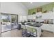 Charming kitchen featuring white cabinets, a center island, and sliding doors for easy access to the outdoor area at 4554 E Coyote Wash Dr, Cave Creek, AZ 85331