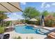 Backyard featuring a sparkling pool, umbrellas, and patio furniture, creating a relaxing outdoor space at 4554 E Coyote Wash Dr, Cave Creek, AZ 85331