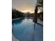 Inviting pool with clear blue water, surrounded by desert landscaping at sunset at 4554 E Coyote Wash Dr, Cave Creek, AZ 85331