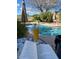 Relaxing poolside with a book and a beer by the refreshing pool on a sunny day at 4554 E Coyote Wash Dr, Cave Creek, AZ 85331