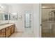 Bathroom featuring tile floors, a walk-in shower and a walk-in closet for extra storage at 4808 E Betty Elyse Ln, Scottsdale, AZ 85254