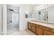 Bathroom with dual sink vanity and a view looking into the bedroom at 4808 E Betty Elyse Ln, Scottsdale, AZ 85254