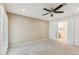 Bedroom with neutral colors, ceiling fan, carpet, and an en suite bathroom at 4808 E Betty Elyse Ln, Scottsdale, AZ 85254