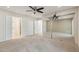 Spacious bedroom with neutral carpet, ceiling fan, and mirrored closet doors at 4808 E Betty Elyse Ln, Scottsdale, AZ 85254