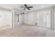 Bright bedroom with neutral walls, carpet, ceiling fan and mirrored closet at 4808 E Betty Elyse Ln, Scottsdale, AZ 85254