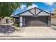Home featuring a two-car garage with exterior stone details and manicured landscaping at 4808 E Betty Elyse Ln, Scottsdale, AZ 85254