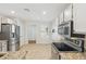 Bright kitchen area features stainless steel appliances, tile backsplash and light tile flooring at 4808 E Betty Elyse Ln, Scottsdale, AZ 85254