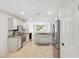 Well-lit kitchen features modern appliances and a neutral color palette and tile flooring at 4808 E Betty Elyse Ln, Scottsdale, AZ 85254