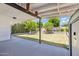 Covered patio overlooking a spacious, well-maintained backyard with trees at 4808 E Betty Elyse Ln, Scottsdale, AZ 85254
