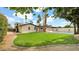 Lush backyard showcasing mature trees, a well-maintained lawn, and a pristine pool for relaxation and recreation at 5109 E Blanche Dr, Scottsdale, AZ 85254