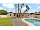 Beautiful backyard featuring a sparkling pool and lush landscaping with elegant desert palms at 5109 E Blanche Dr, Scottsdale, AZ 85254