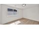 Bedroom with wood floors, white walls, and a window providing natural light at 5109 E Blanche Dr, Scottsdale, AZ 85254