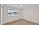 Bedroom with light wood floors and a window overlooking the front yard at 5109 E Blanche Dr, Scottsdale, AZ 85254