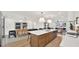 Open kitchen and dining area with an island, bar seating, pendant lights, and views of the living room and front yard at 5109 E Blanche Dr, Scottsdale, AZ 85254