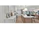 Modern kitchen with white cabinets, quartz countertops, stainless appliances, and island with pendant lighting at 5109 E Blanche Dr, Scottsdale, AZ 85254