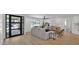 Bright, open-concept living room with neutral tones, comfortable seating, wood floors, and a large window view at 5109 E Blanche Dr, Scottsdale, AZ 85254