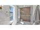 Modern shower with glass enclosure, tiled walls, rainfall shower head, and natural light from a window at 5109 E Blanche Dr, Scottsdale, AZ 85254
