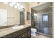 Updated bathroom with granite counters, dark cabinets, and tiled walk-in shower at 5345 E Van Buren St # 305, Phoenix, AZ 85008