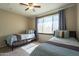 Bedroom featuring two twin beds, large window, and ceiling fan at 5345 E Van Buren St # 305, Phoenix, AZ 85008
