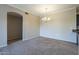 Bright dining room with carpet, chandelier, and archway to the living room at 5345 E Van Buren St # 305, Phoenix, AZ 85008
