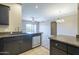 Kitchen showcasing dark cabinets, granite countertops, and stainless steel appliances, adjacent to the living area at 5345 E Van Buren St # 305, Phoenix, AZ 85008