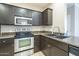 Well-equipped kitchen featuring dark cabinets, stainless steel appliances, and granite countertops at 5345 E Van Buren St # 305, Phoenix, AZ 85008