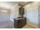 Kitchen area with granite countertops, a storage cabinet, and connection to a carpeted dining or living area at 5345 E Van Buren St # 305, Phoenix, AZ 85008