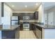 Kitchen showcasing stainless steel appliances, granite countertops, and a breakfast bar area at 5345 E Van Buren St # 305, Phoenix, AZ 85008