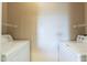 Functional laundry room with washer, dryer, and wire shelving at 5345 E Van Buren St # 305, Phoenix, AZ 85008