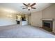 Open-concept living area with carpet and a fireplace, seamlessly connecting to the kitchen space at 5345 E Van Buren St # 305, Phoenix, AZ 85008