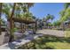 Outdoor picnic area with a shaded pergola, BBQ grills, and a volleyball court for residents at 5345 E Van Buren St # 305, Phoenix, AZ 85008