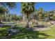 Beautiful community pond featuring a rock waterfall, lush landscaping, and serene water features at 5345 E Van Buren St # 305, Phoenix, AZ 85008