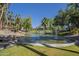 A scenic view of the community pond with fountains, rock features, and well-manicured lawns at 5345 E Van Buren St # 305, Phoenix, AZ 85008