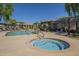 Pool area featuring a hot tub, swimming pool, and lounge seating, perfect for relaxation at 5345 E Van Buren St # 305, Phoenix, AZ 85008