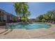 Inviting community pool with pristine blue water, surrounded by well-maintained landscaping and lounge chairs at 5345 E Van Buren St # 305, Phoenix, AZ 85008
