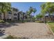 Sandy volleyball court with lush trees and building exterior in the background at 5345 E Van Buren St # 305, Phoenix, AZ 85008