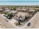 Expansive aerial view of a beige two-story home with a tile roof, surrounded by lush landscaping and a sparkling blue pool at 551 E Sun Valley Farms Ln, San Tan Valley, AZ 85140