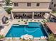 Aerial view of backyard featuring pool, covered patio, and outdoor lounge areas at 551 E Sun Valley Farms Ln, San Tan Valley, AZ 85140