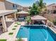 Aerial view showcasing pool, outdoor kitchen, lounge area, and lush landscaping at 551 E Sun Valley Farms Ln, San Tan Valley, AZ 85140