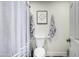 Clean bathroom with a toilet, and shower with a patterned shower curtain at 551 E Sun Valley Farms Ln, San Tan Valley, AZ 85140