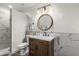 Nicely decorated bathroom with white walls, toilet, marble sink, and walk-in shower at 551 E Sun Valley Farms Ln, San Tan Valley, AZ 85140